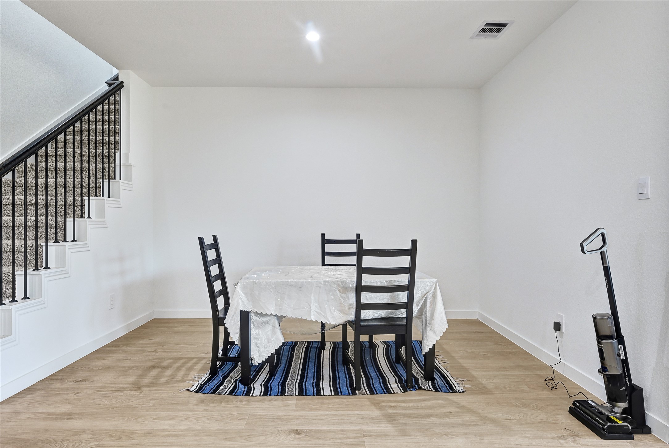 31703 Theodore Bend Drive Fulshear, TX 77441 - Photo 11 of 24 a view of a dining room with furniture and wooden floor