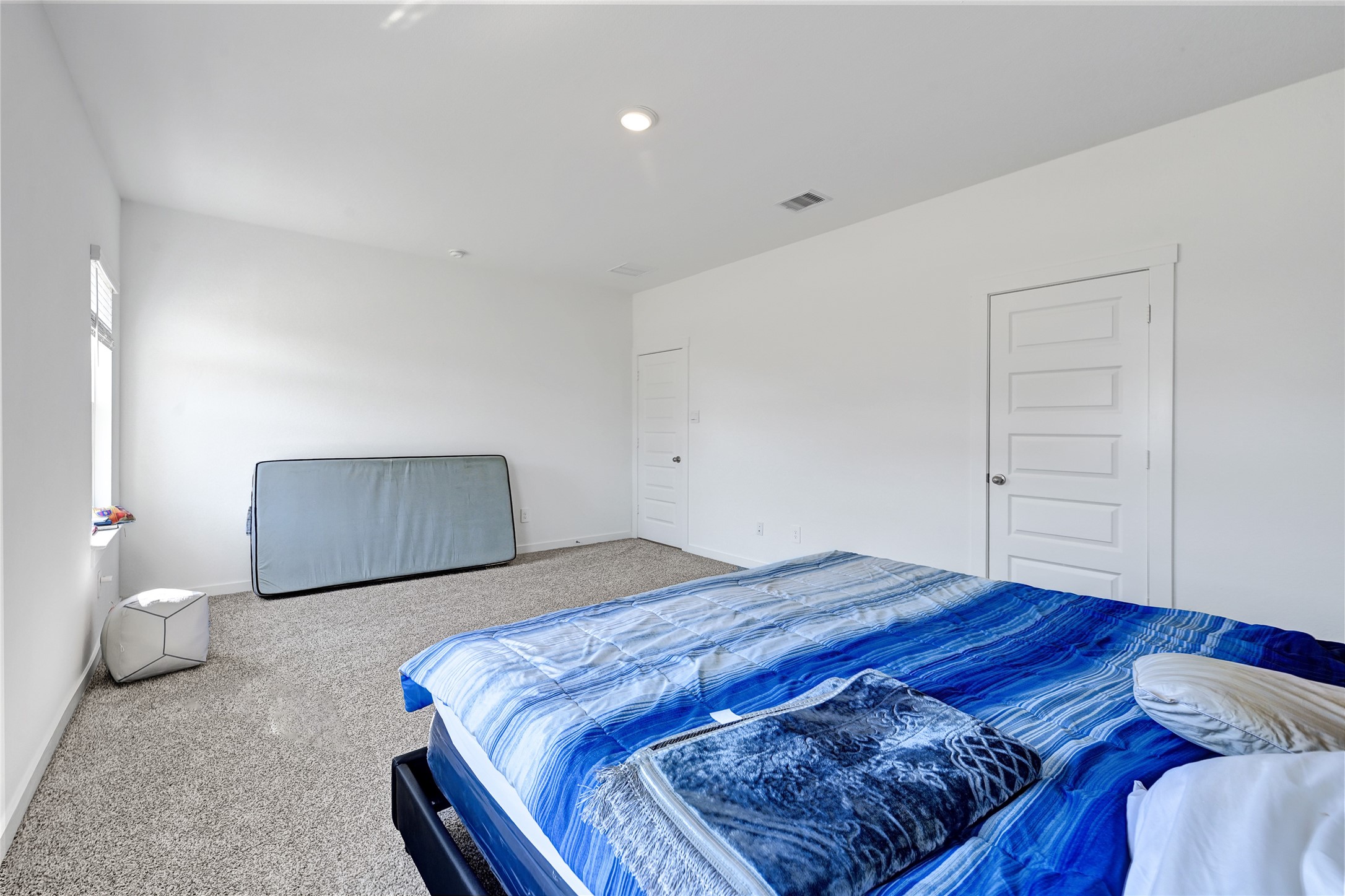31703 Theodore Bend Drive Fulshear, TX 77441 - Photo 14 of 24 a bedroom with a bed and wooden floor