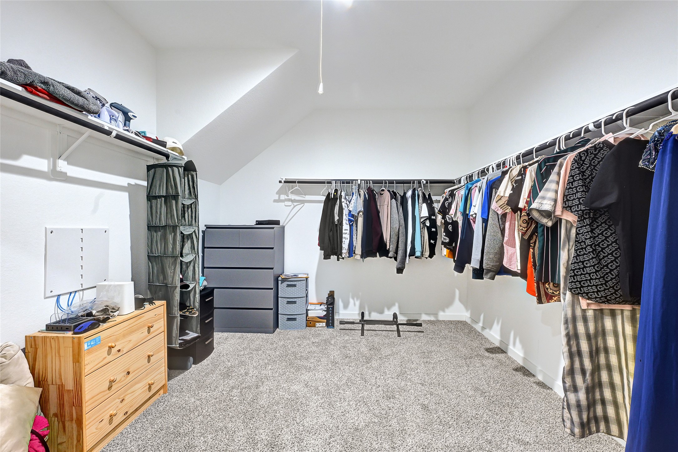 31703 Theodore Bend Drive Fulshear, TX 77441 - Photo 18 of 24 a view of walk in closet with clothes and shoes