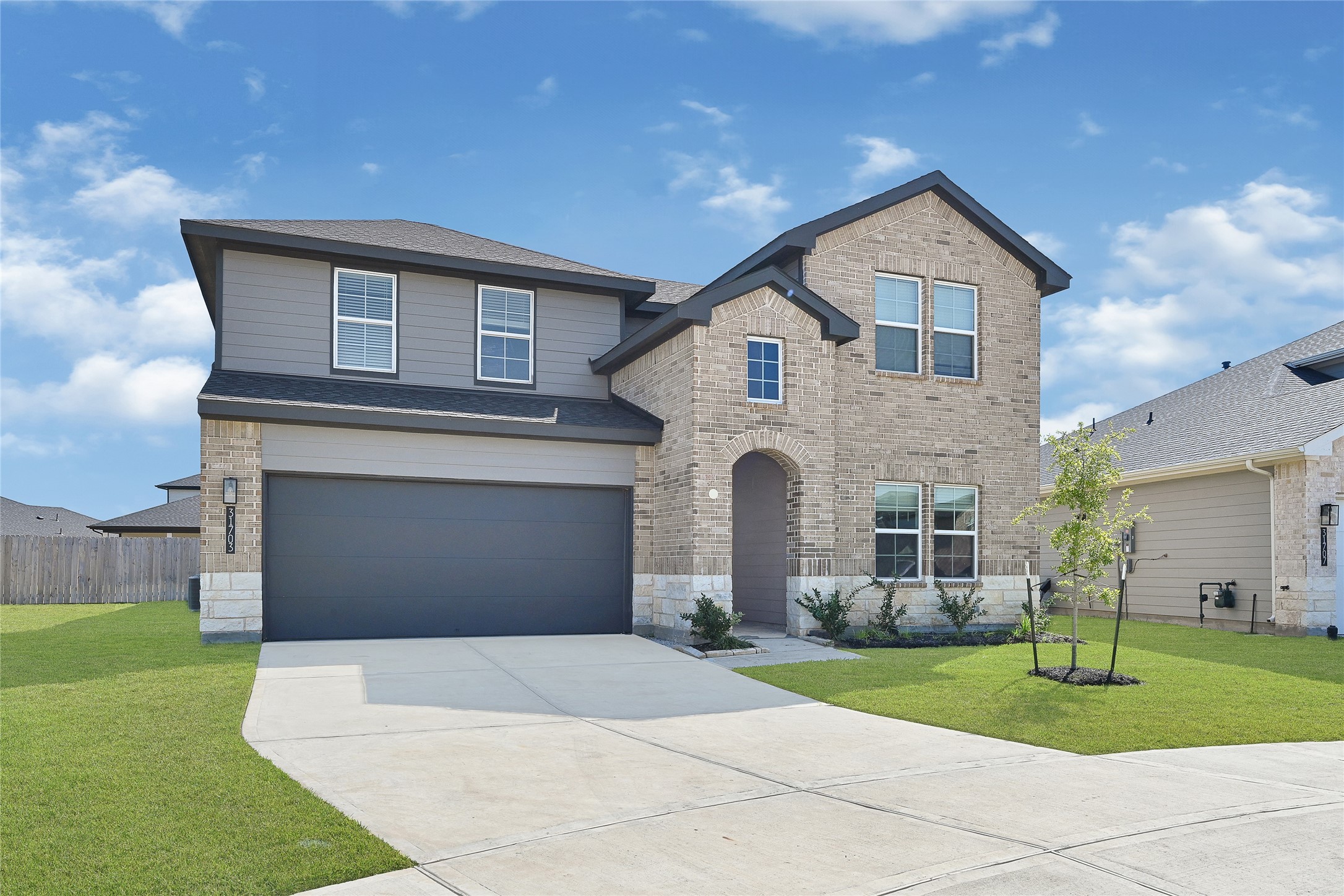 31703 Theodore Bend Drive Fulshear, TX 77441 - Photo 2 of 24 a front view of a house with a yard and garage
