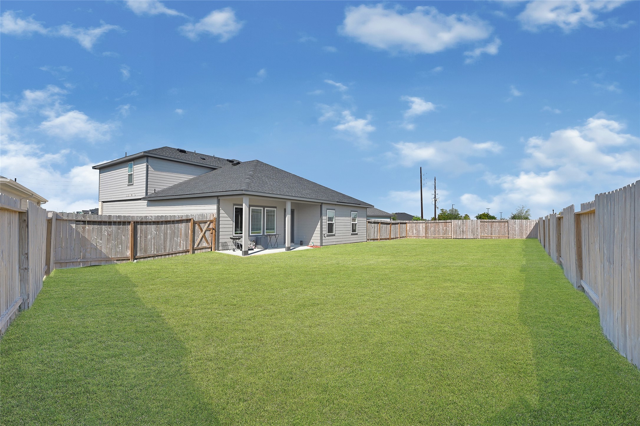 31703 Theodore Bend Drive Fulshear, TX 77441 - Photo 23 of 24 a yellow and red house with a big yard and big trees