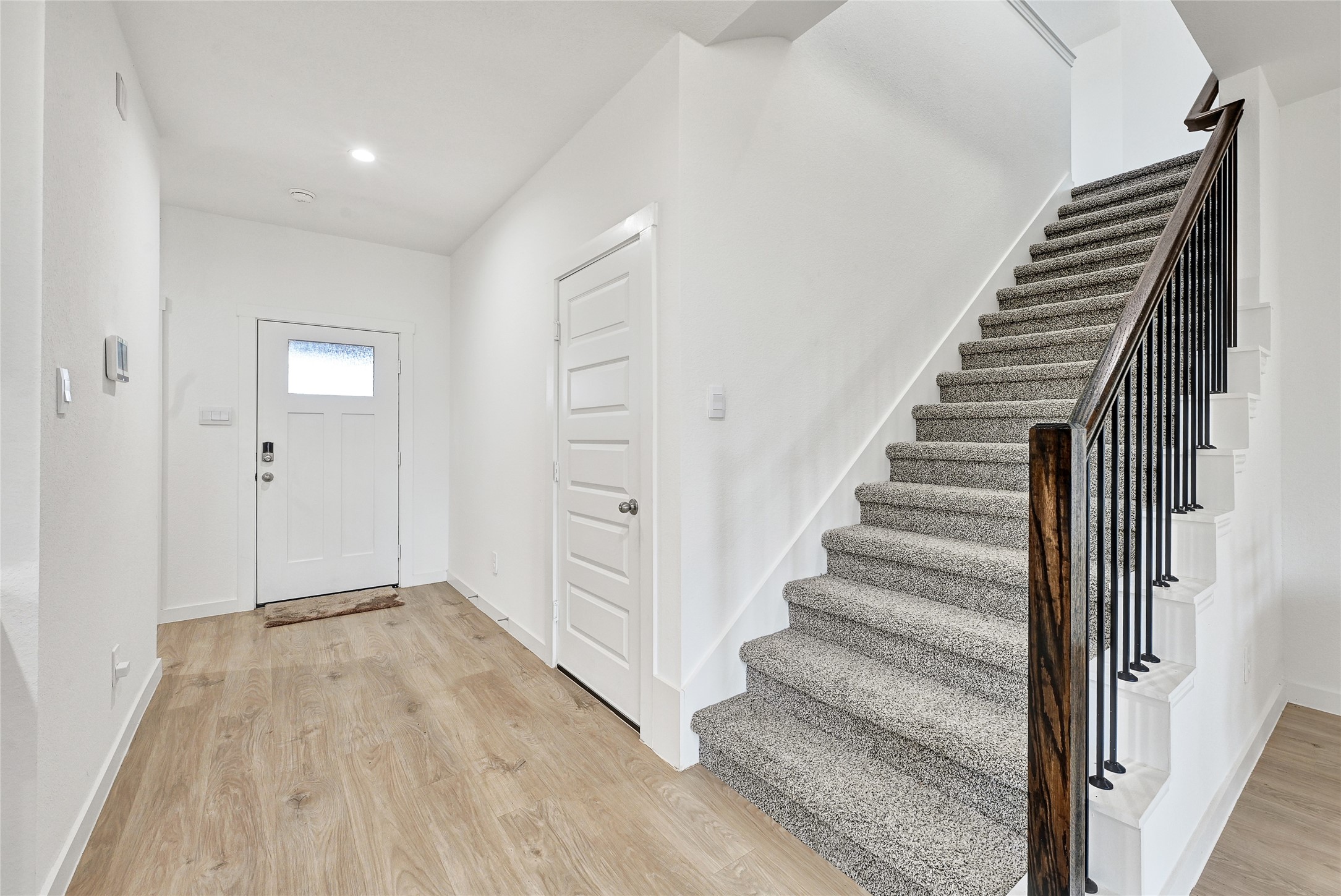 31703 Theodore Bend Drive Fulshear, TX 77441 - Photo 4 of 24 a view of a hallway with wooden floor and entryway