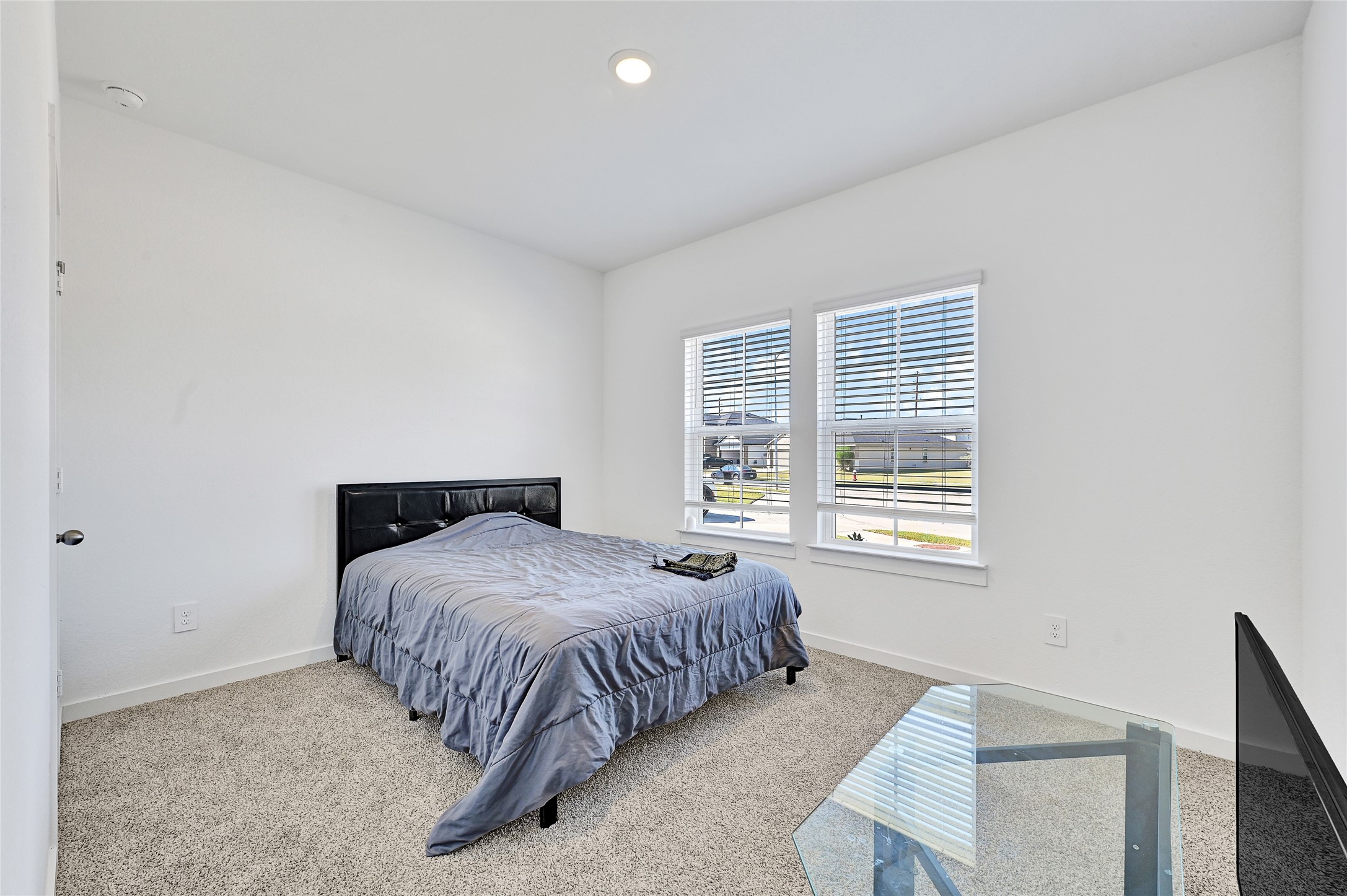 31703 Theodore Bend Drive Fulshear, TX 77441 - Photo 5 of 24 a bedroom with a bed and a window