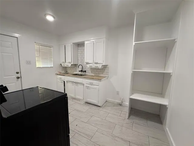 a kitchen with a sink cabinets and appliances