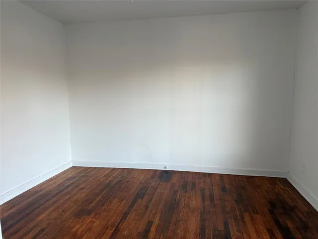 a view of an empty room and wooden floor