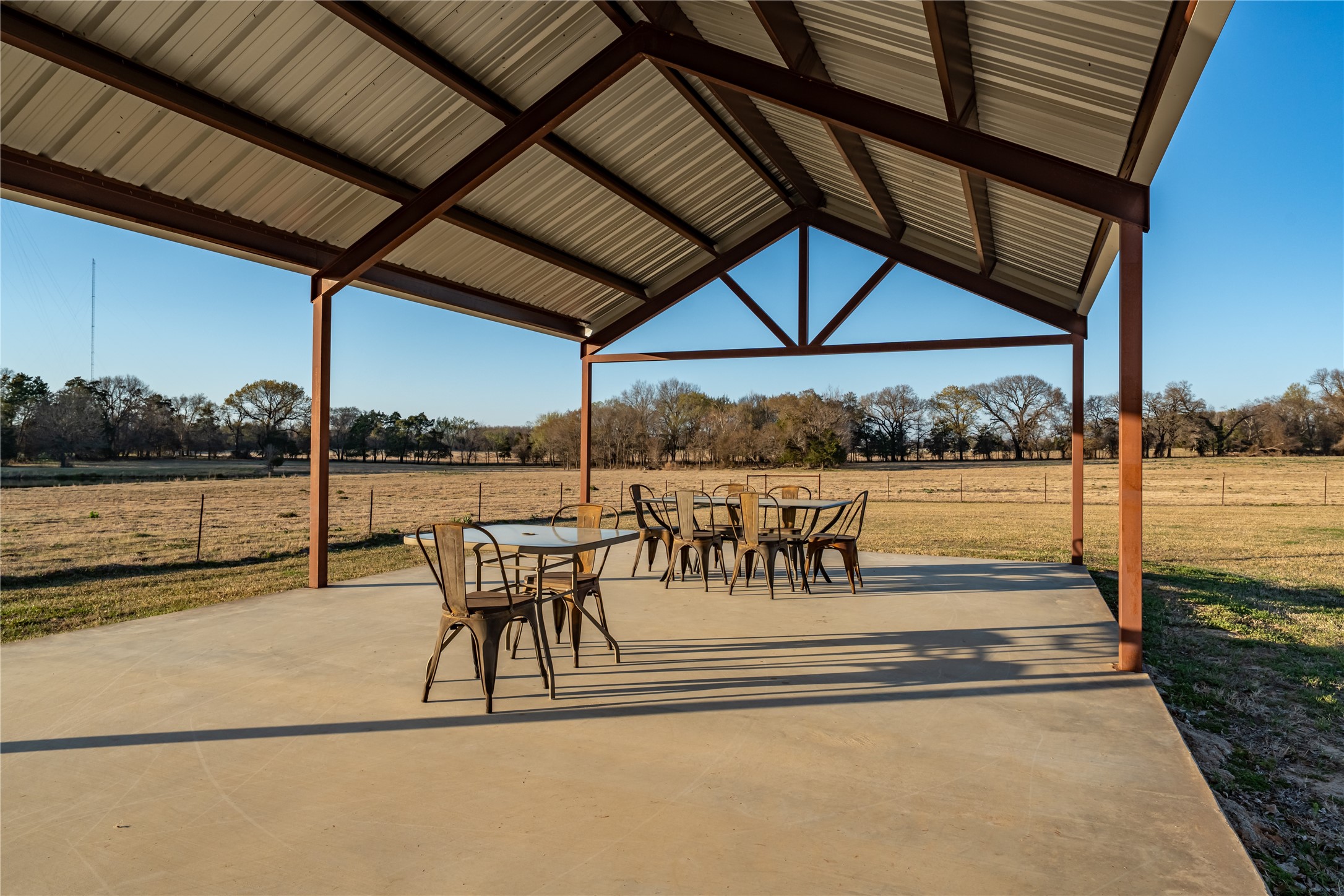 6751 County Road 4710 Larue, TX 75770 - Photo 12 of 47 a view of a patio with a table and chairs under an umbrella
