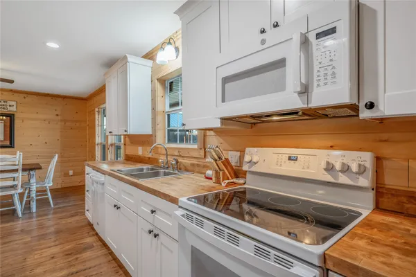 a kitchen with sink stove and cabinets