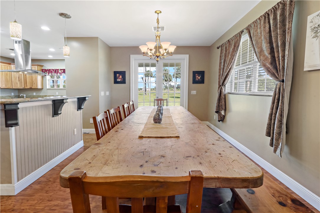 6045 21st Street Southwest Vero Beach, FL 32968 - Photo 11 of 36 a view of a dining room with furniture window and wooden floor