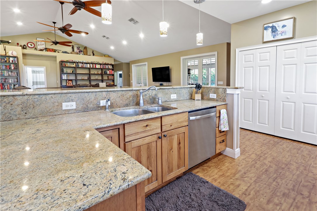 6045 21st Street Southwest Vero Beach, FL 32968 - Photo 13 of 36 a kitchen with kitchen island granite countertop a sink and a stove top oven