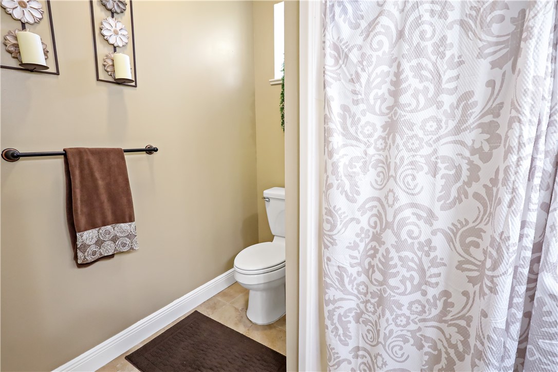 6045 21st Street Southwest Vero Beach, FL 32968 - Photo 18 of 36 a white toilet sitting next to a shower curtain