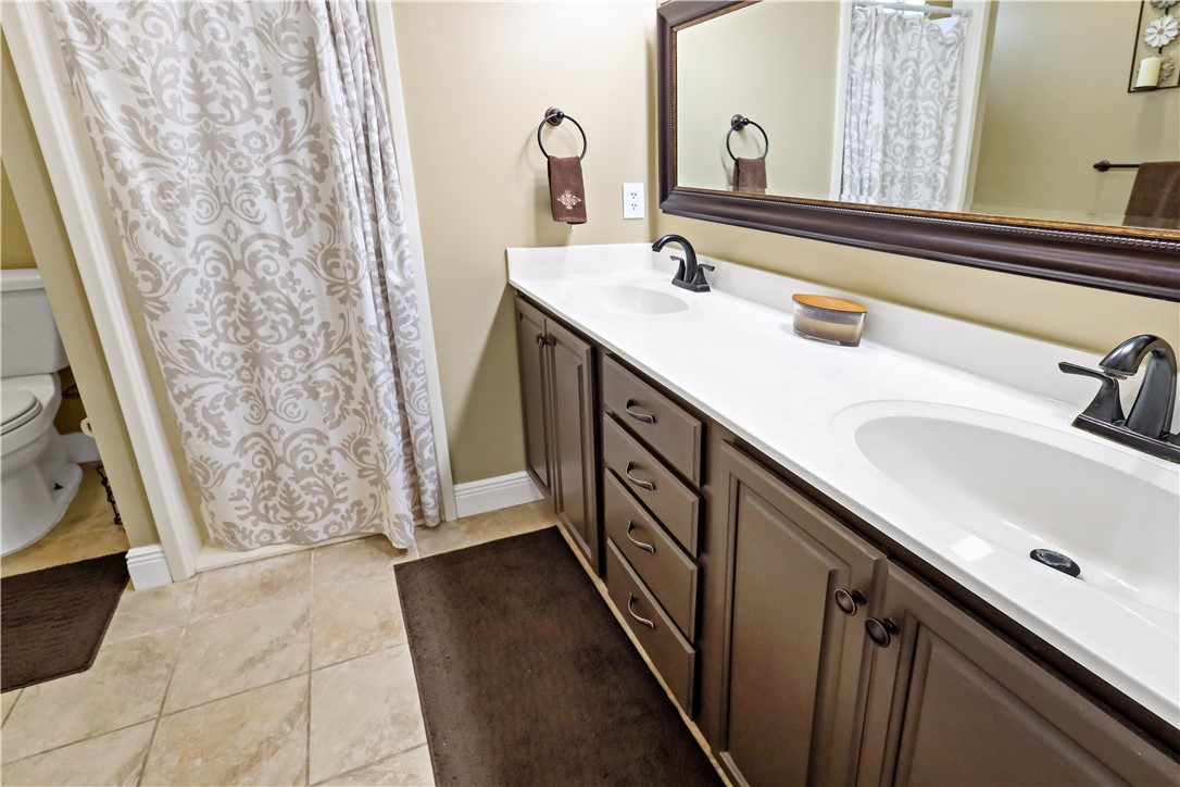6045 21st Street Southwest Vero Beach, FL 32968 - Photo 19 of 36 a bathroom with a double vanity sink and a mirror