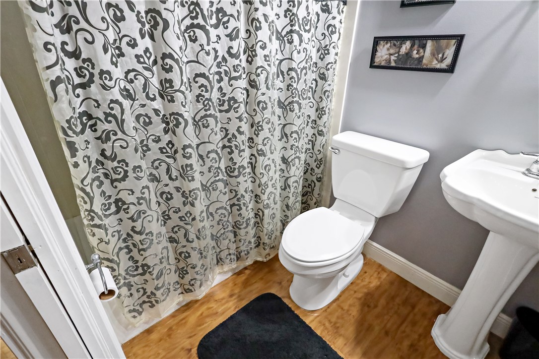 6045 21st Street Southwest Vero Beach, FL 32968 - Photo 21 of 36 a white toilet sitting next to a shower curtain