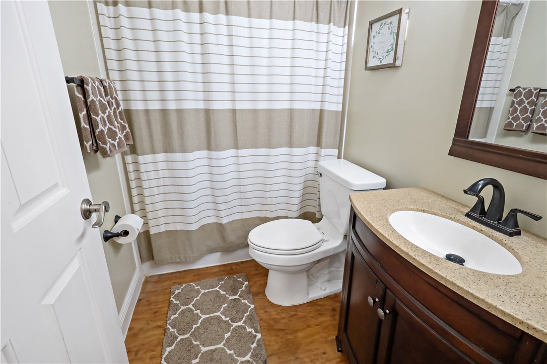 6045 21st Street Southwest Vero Beach, FL 32968 - Photo 26 of 36 a bathroom with a granite countertop toilet sink and mirror