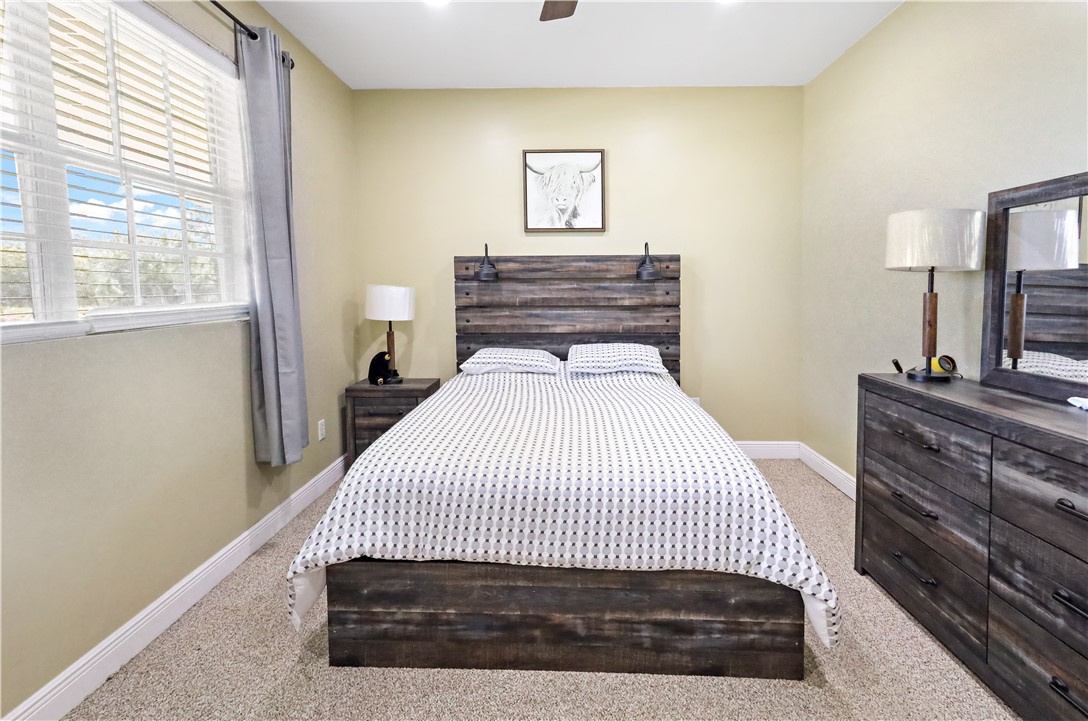 6045 21st Street Southwest Vero Beach, FL 32968 - Photo 28 of 36 a bedroom with a bed and wooden floor