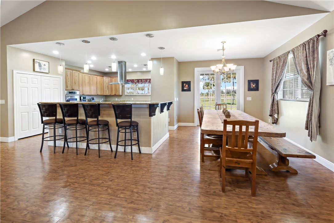 6045 21st Street Southwest Vero Beach, FL 32968 - Photo 29 of 36 a view of a dining area with furniture window and wooden floor