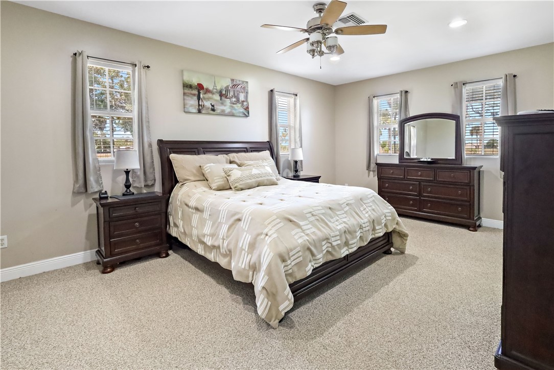 6045 21st Street Southwest Vero Beach, FL 32968 - Photo 31 of 36 a bedroom with a bed dresser and wooden floor