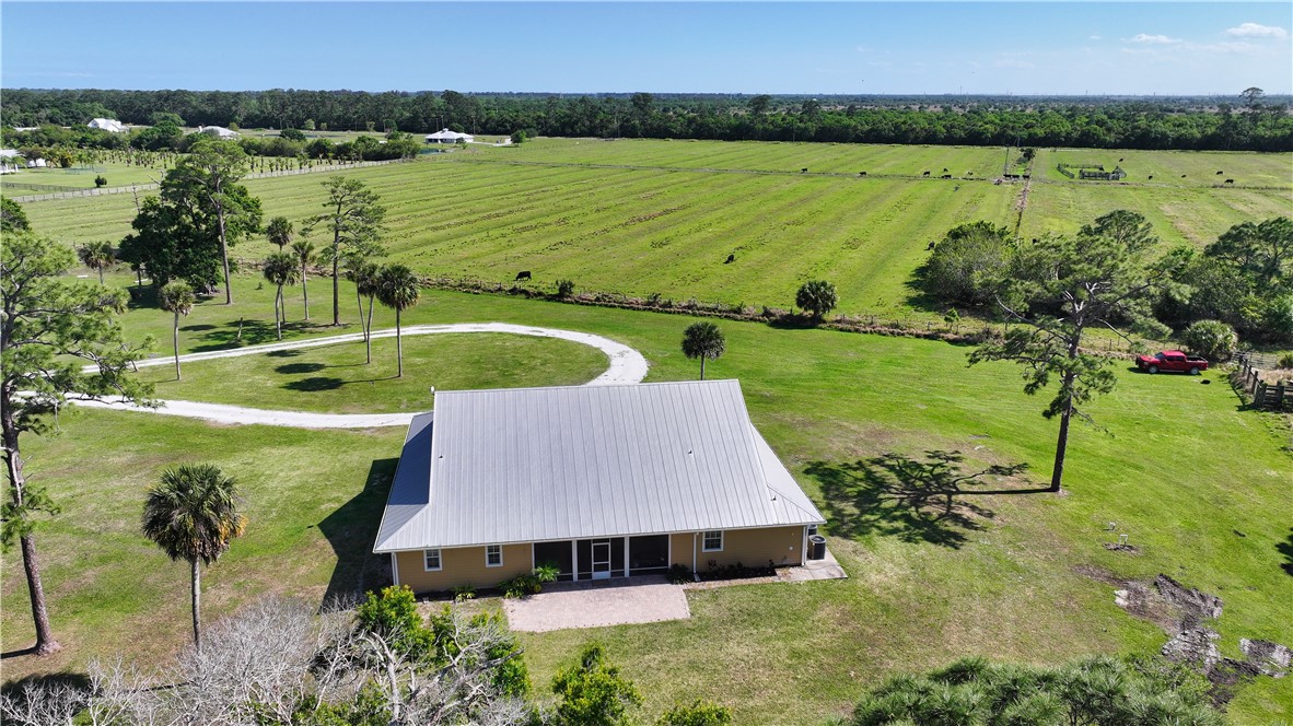 6045 21st Street Southwest Vero Beach, FL 32968 - Photo 5 of 36 a view of a lake with a yard and outdoor seating