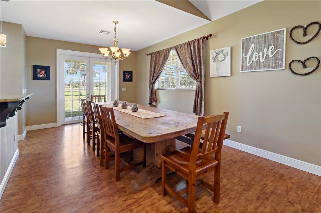 6045 21st Street Southwest Vero Beach, FL 32968 - Photo 10 of 36 a view of a dining room with furniture window and wooden floor