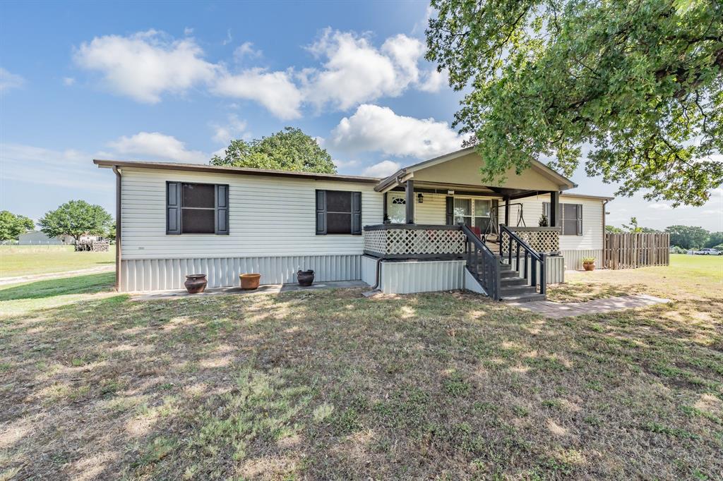 231 Prairie Lane Azle, TX 76020 - Photo 1 of 1 Manufactured / mobile home featuring a front yard and a porch