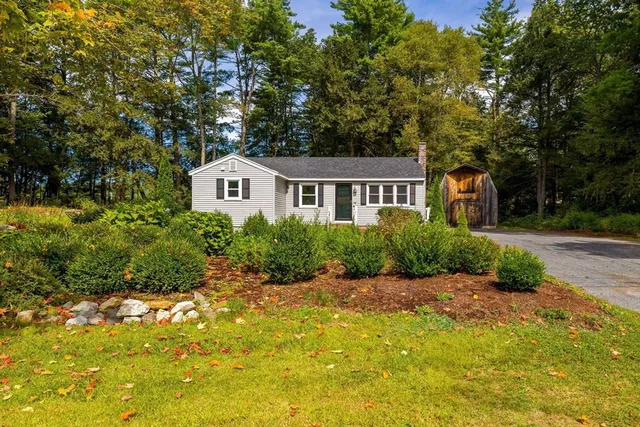 a front view of a house with a garden