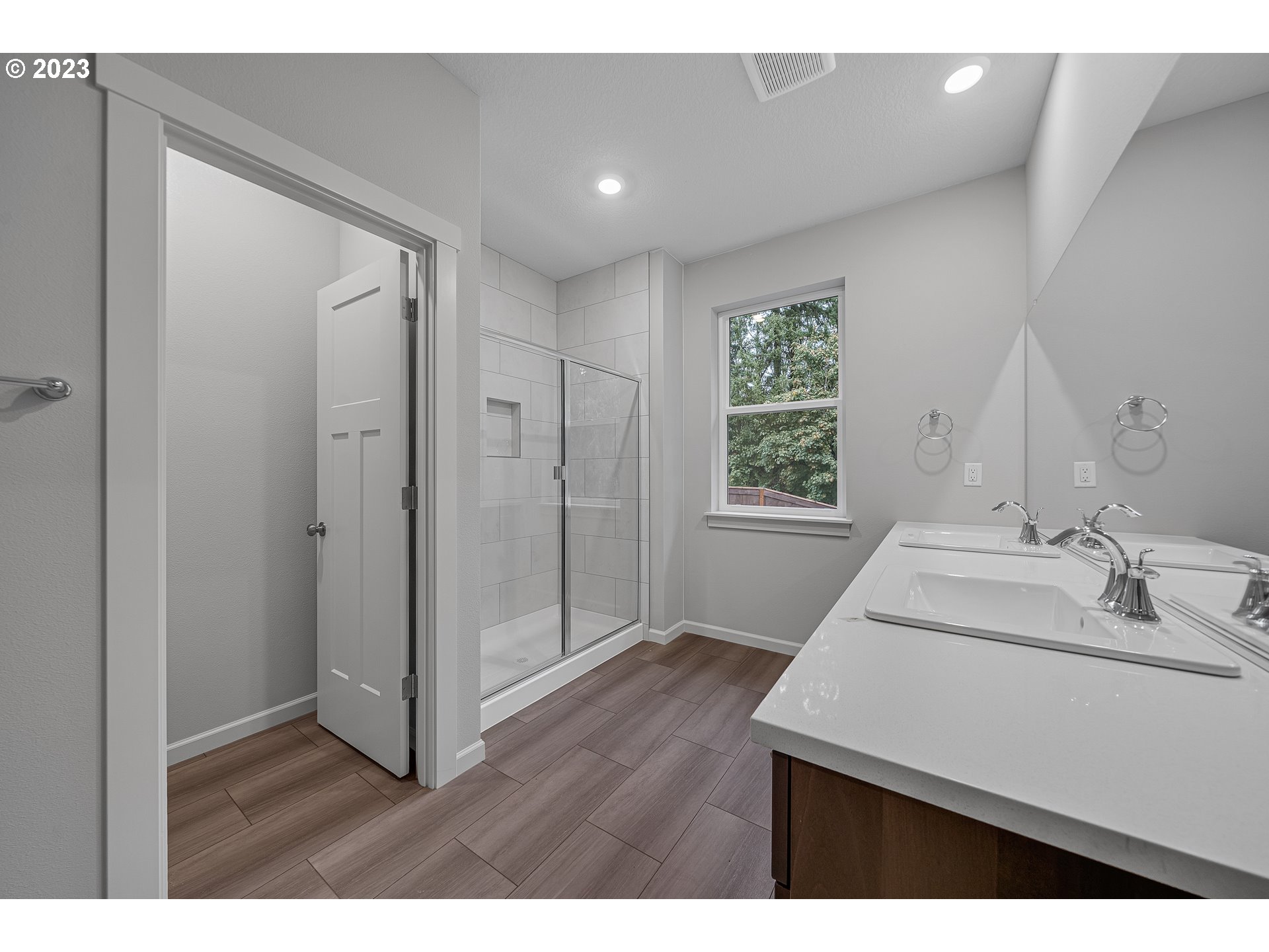 2609 South 4th Way Ridgefield, WA 98642 - Photo 17 of 25 a bathroom with a sink a mirror and a shower