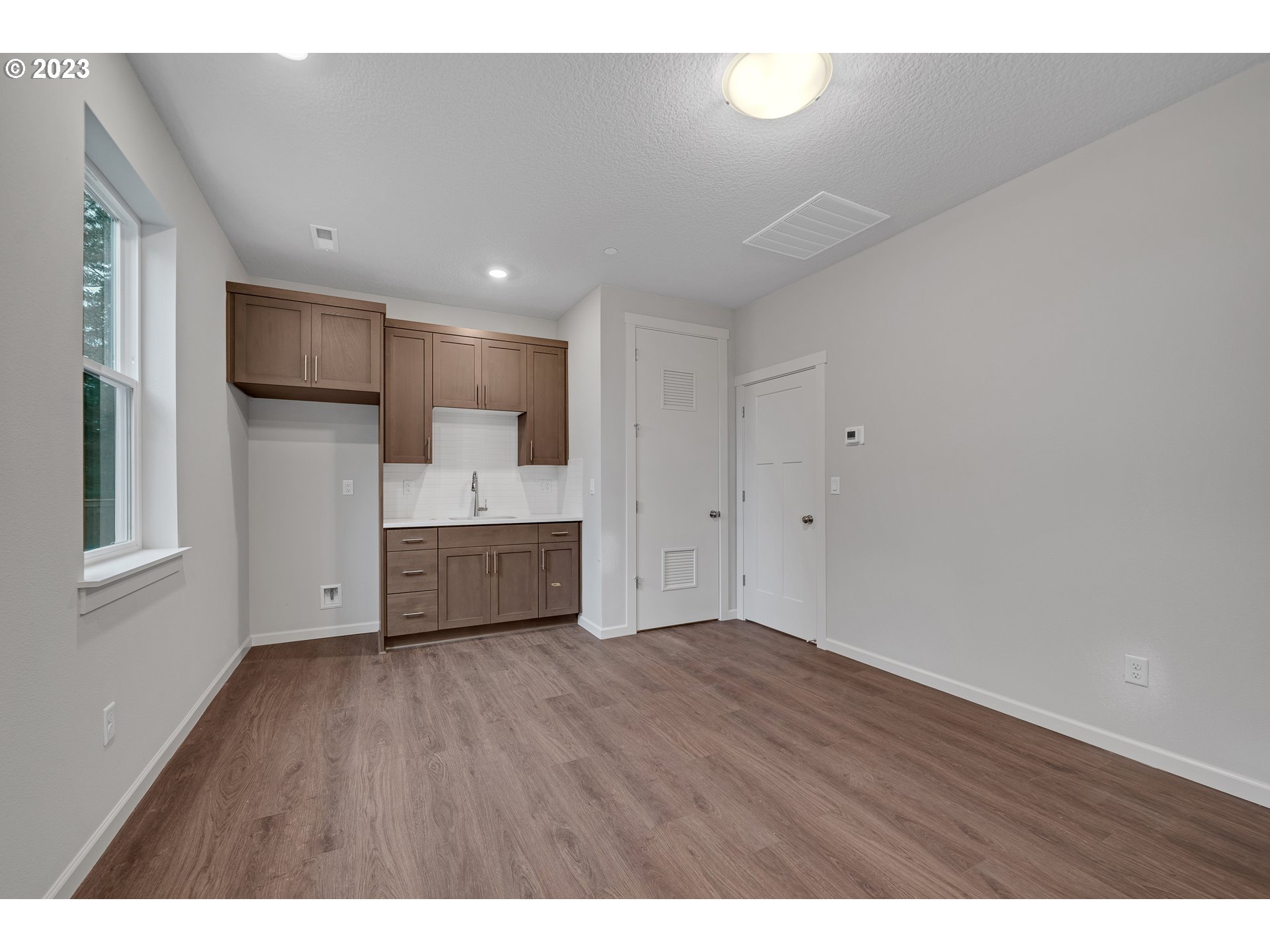2609 South 4th Way Ridgefield, WA 98642 - Photo 21 of 25 a view of a kitchen with a sink and a refrigerator