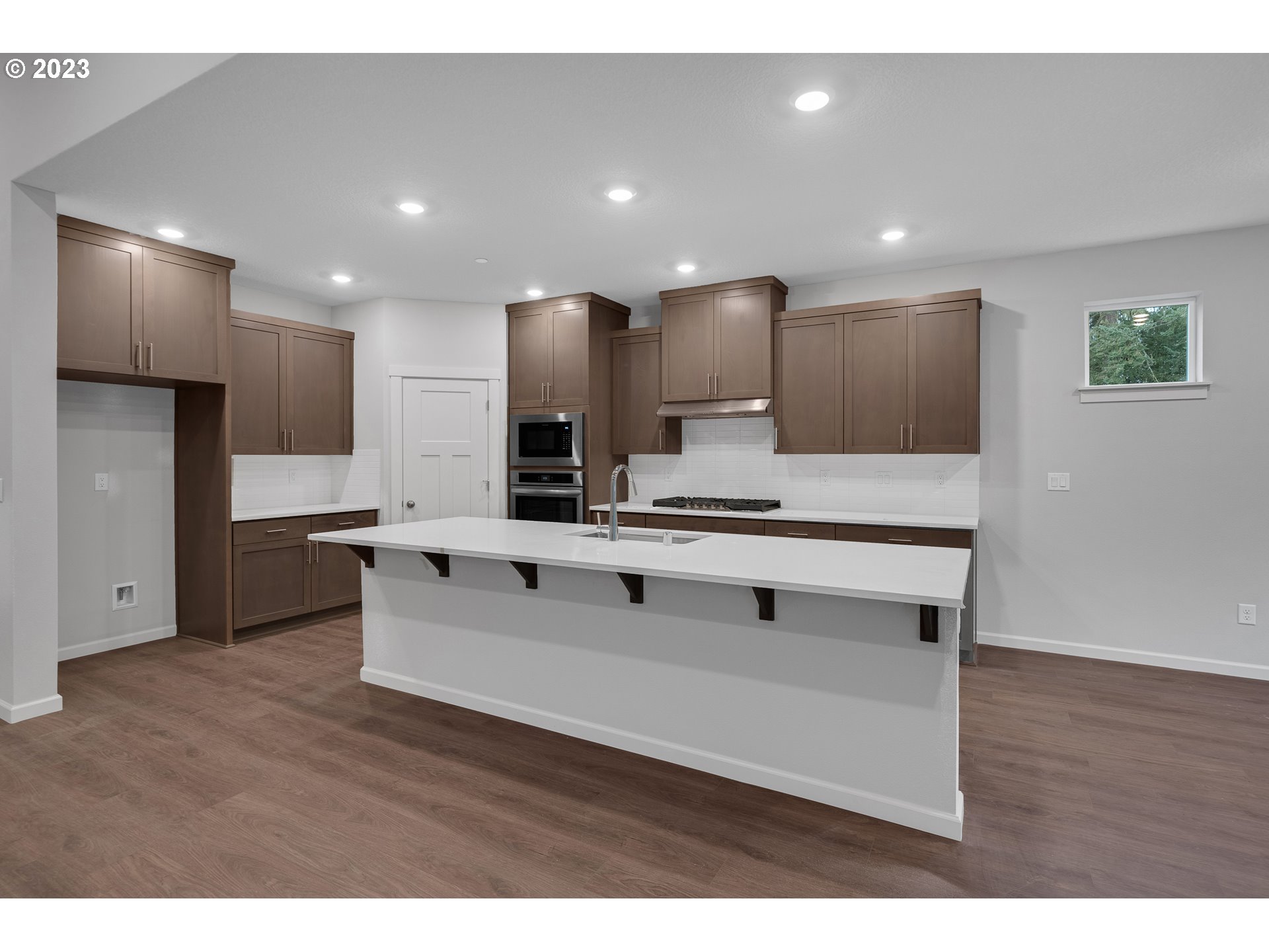 2609 South 4th Way Ridgefield, WA 98642 - Photo 8 of 25 a living room with stainless steel appliances kitchen island furniture and wooden floor