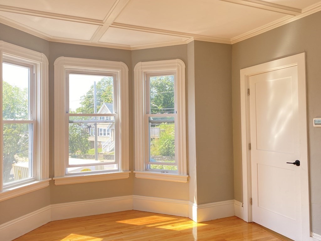 51 Walnut Street Lynn, MA 01905 - Photo 15 of 37 a view of a bedroom with a bed and wooden floor