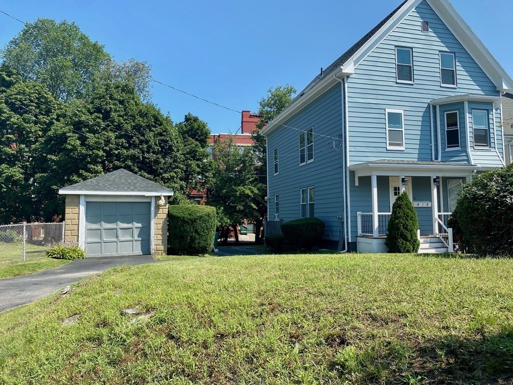 51 Walnut Street Lynn, MA 01905 - Photo 2 of 37 a front view of a house with yard and green space