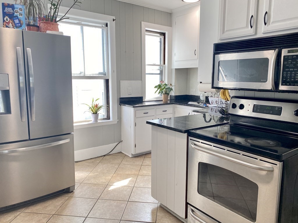 51 Walnut Street Lynn, MA 01905 - Photo 22 of 37 a kitchen with a stove microwave and refrigerator