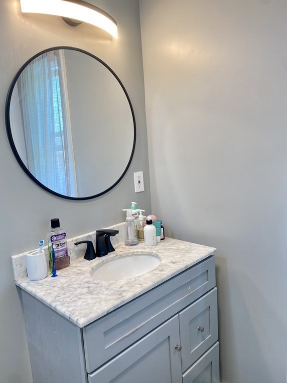 51 Walnut Street Lynn, MA 01905 - Photo 23 of 37 a bathroom with a sink and a mirror and vanity