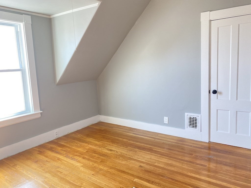 51 Walnut Street Lynn, MA 01905 - Photo 25 of 37 a view of empty room with wooden floor and fan