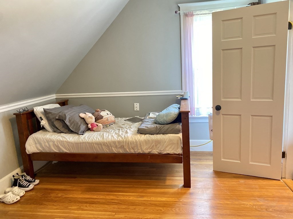 51 Walnut Street Lynn, MA 01905 - Photo 31 of 37 a bedroom with a bed and wooden floor