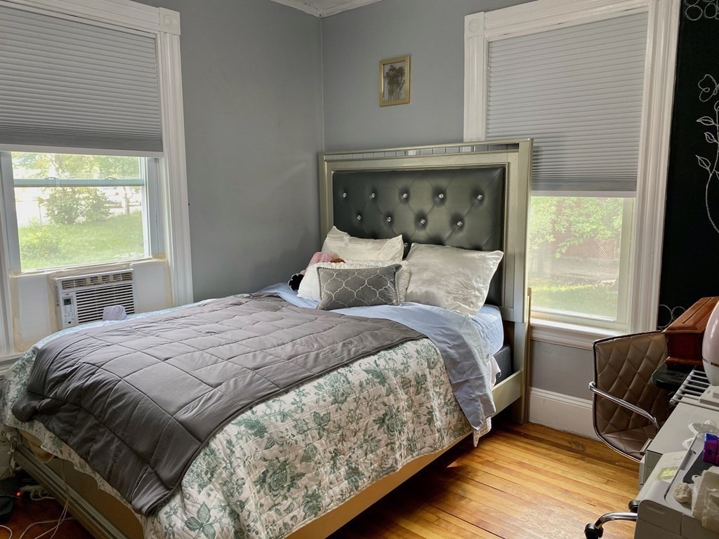 51 Walnut Street Lynn, MA 01905 - Photo 33 of 37 a bedroom with a bed and wooden floor