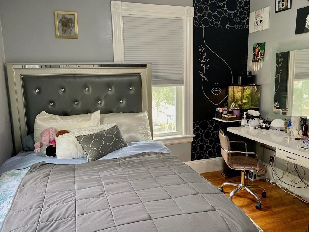 51 Walnut Street Lynn, MA 01905 - Photo 34 of 37 a bedroom with a large bed and a flat tv screen on the dresser