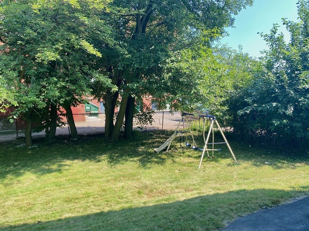 51 Walnut Street Lynn, MA 01905 - Photo 10 of 37 a view of a backyard with a slide