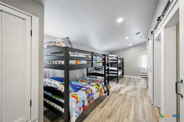a bedroom with furniture and a flat screen tv