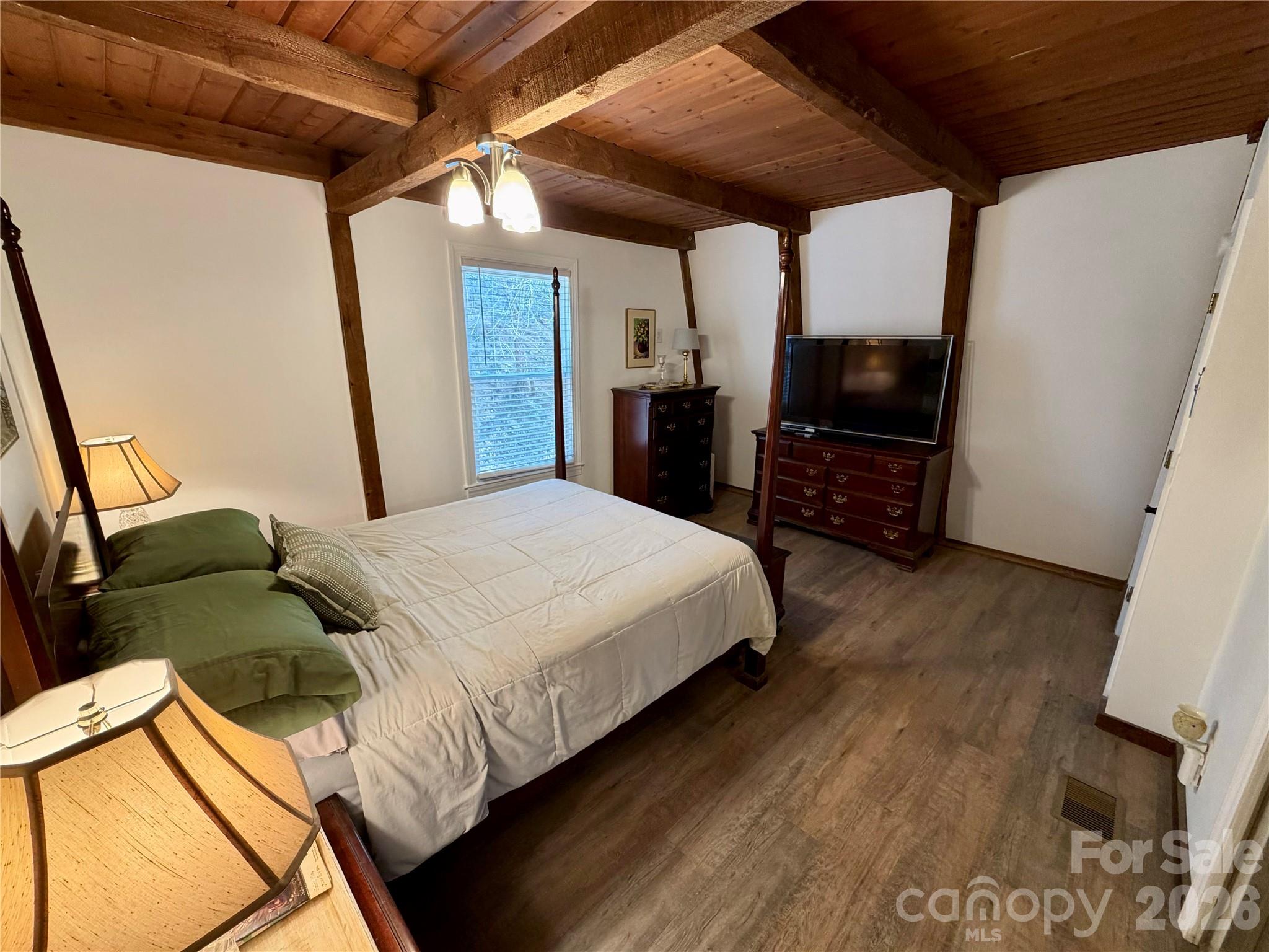 282 Calhoun Trail Rutherfordton, NC 28139 - Photo 17 of 48 a bedroom with a bed a flat screen tv and a mirror