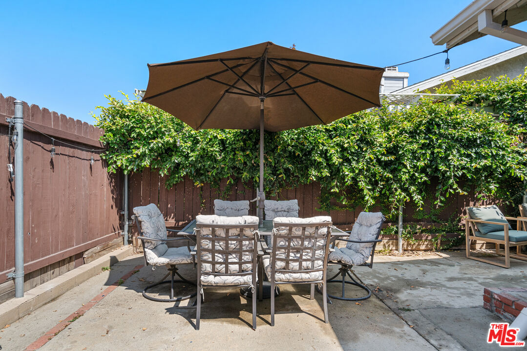 12309 Clover Road Pacoima, CA 91331 - Photo 13 of 15 a view of an outdoor sitting area with couch and umbrella