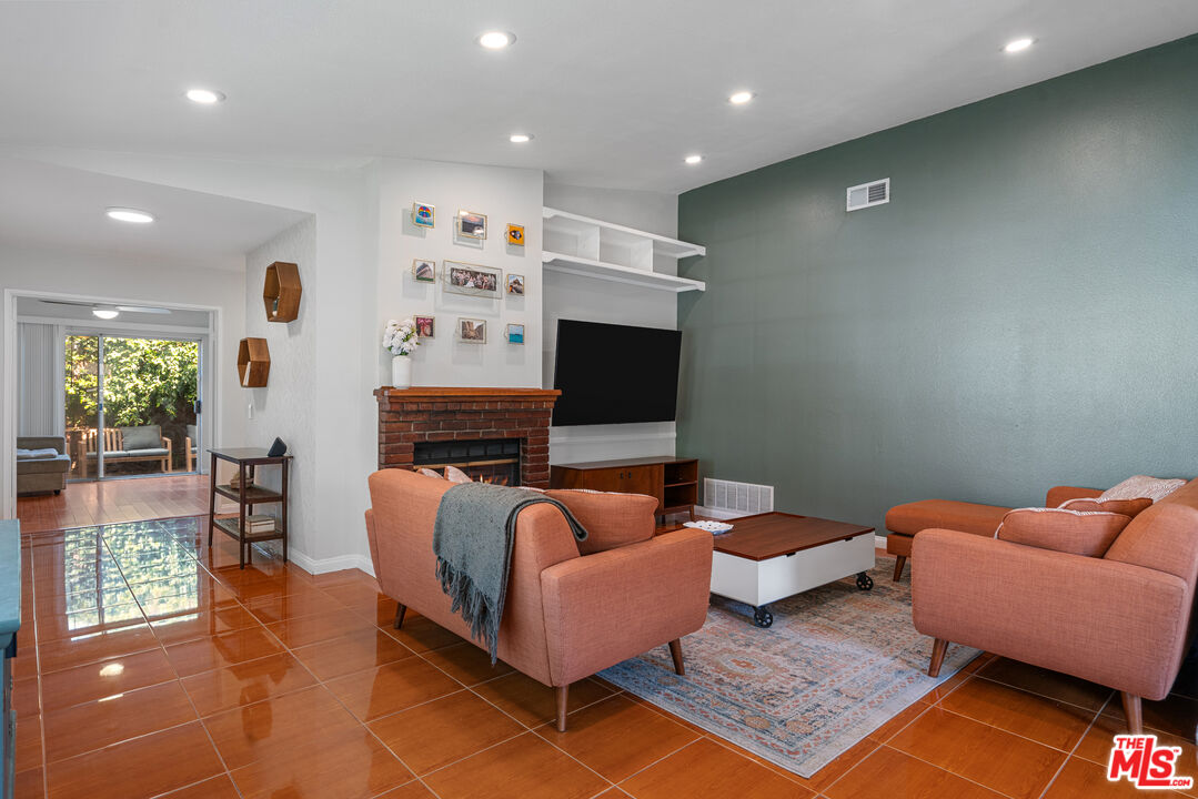 12309 Clover Road Pacoima, CA 91331 - Photo 3 of 15 a living room with furniture and a flat screen tv