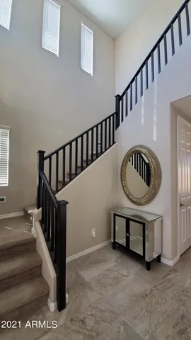 a view of staircase with furniture and a window