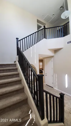 a view of staircase with white walls and a window