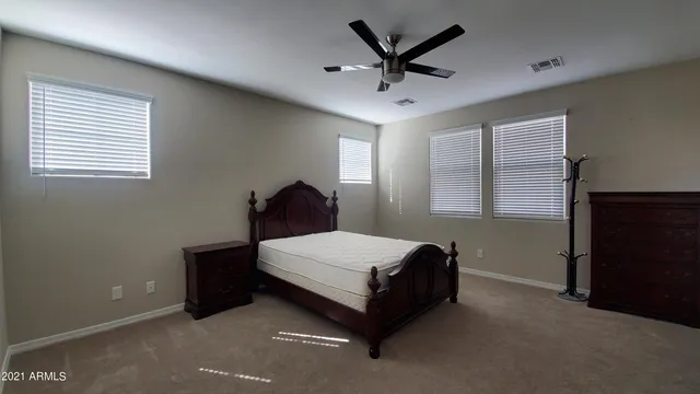 a spacious bedroom with a bed and window