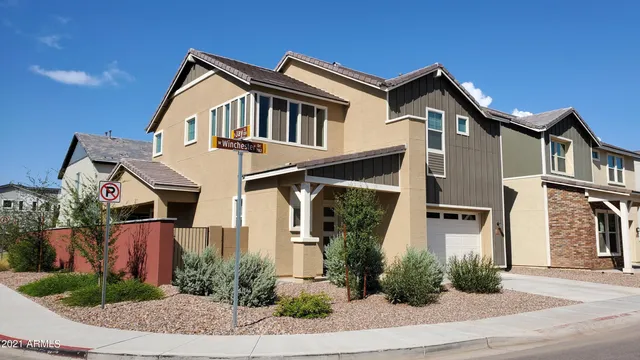 a front view of a house with plants and entryway
