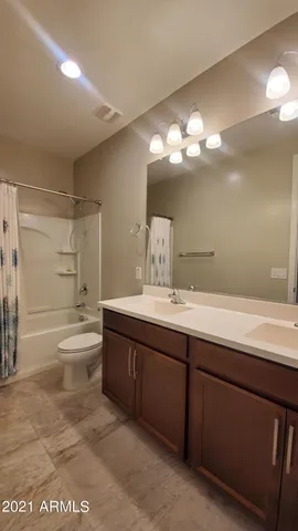 a bathroom with a double vanity sink and a bathtub