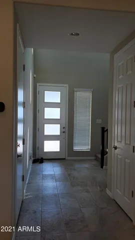 a view of empty room with window and stairs