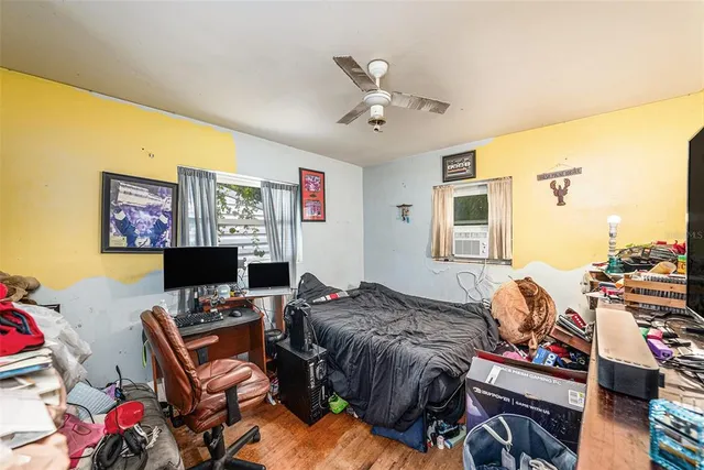 a bedroom with furniture and a flat screen tv
