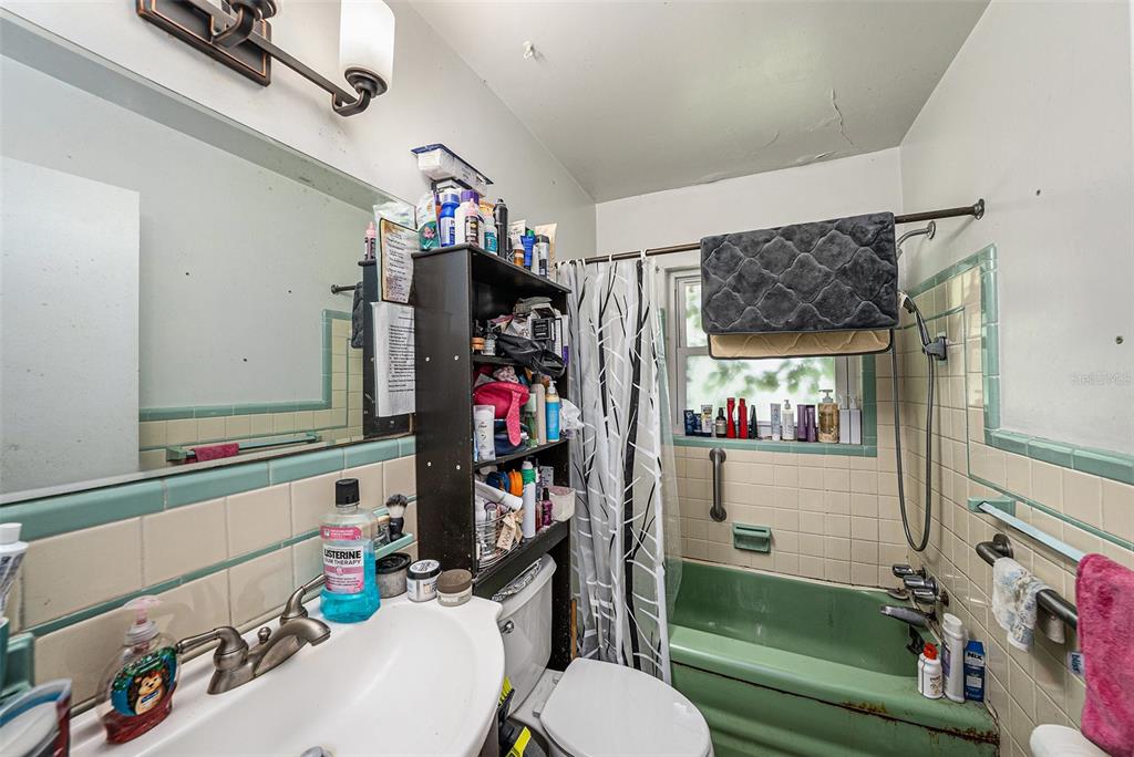 1580 Tuscola Road Clearwater, FL 33756 - Photo 14 of 15 a bathroom with a sink mirror vanity and toilet