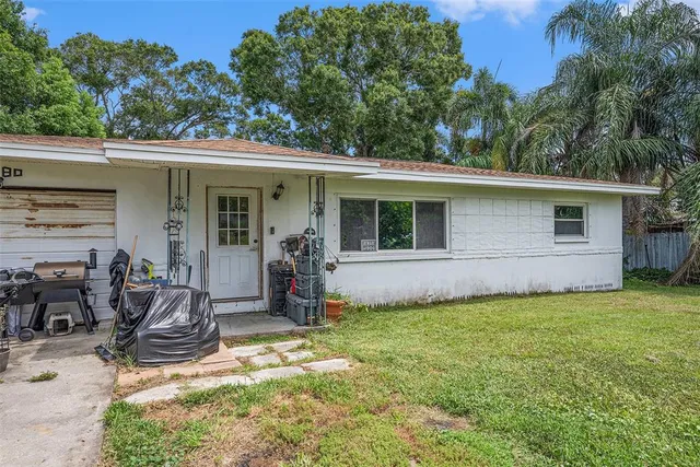 a view of a backyard with plants and a patio
