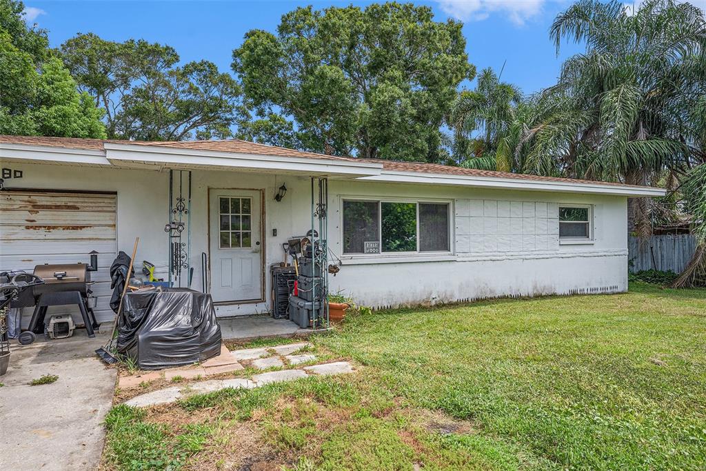 1580 Tuscola Road Clearwater, FL 33756 - Photo 8 of 15 a view of a backyard with plants and a patio